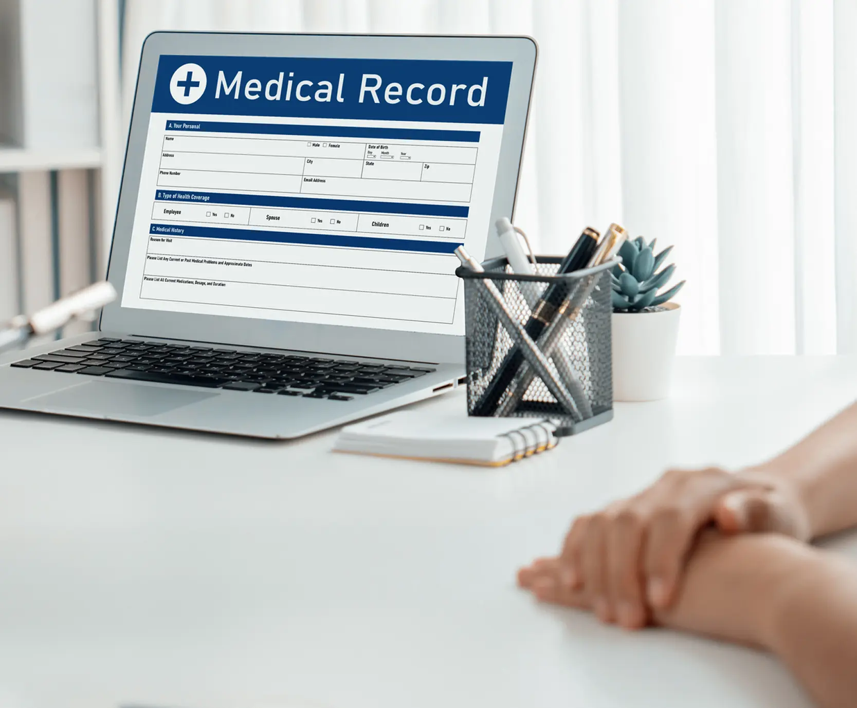 Laptop displaying medical record form