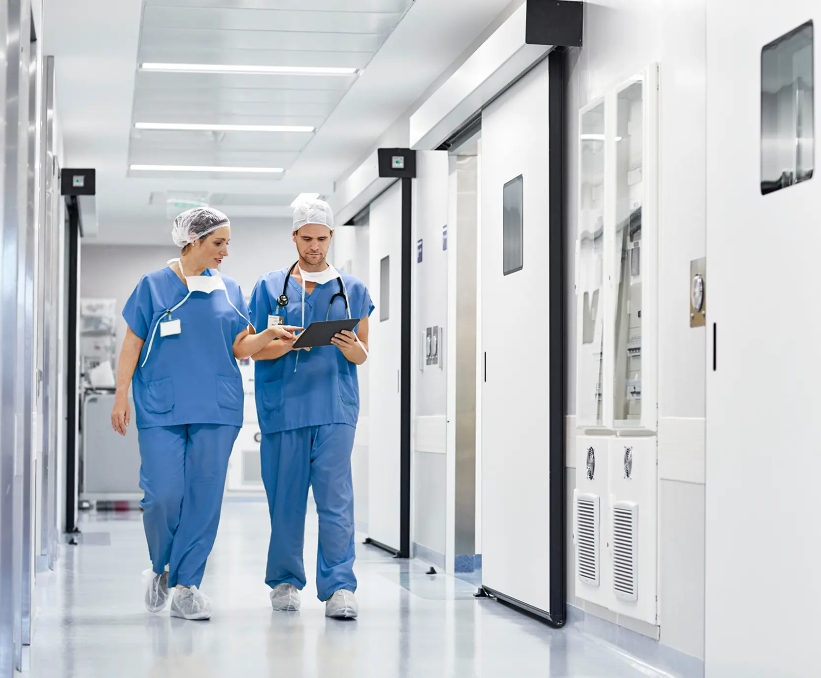 Healthcare professionals walking in hospital corridor